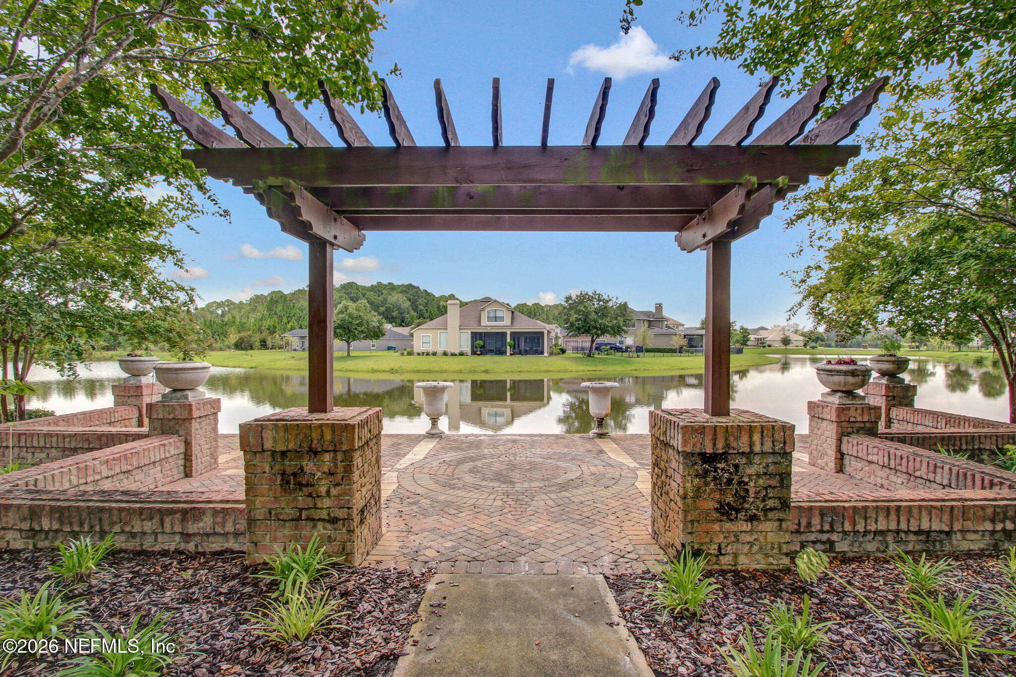 12198 Ridge Crossing Way Jacksonville, FL 32226 - Photo 57 of 67 a view of a patio with chairs and floor to ceiling window next to a yard