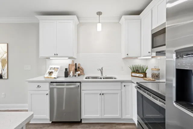 a kitchen with stainless steel appliances granite countertop a sink and a stove
