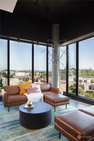 a living room with furniture and a floor to ceiling window
