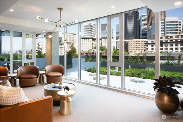 a living room with furniture and a floor to ceiling window