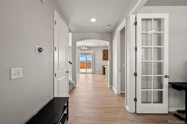 a view of a hallway with wooden floor and entryway
