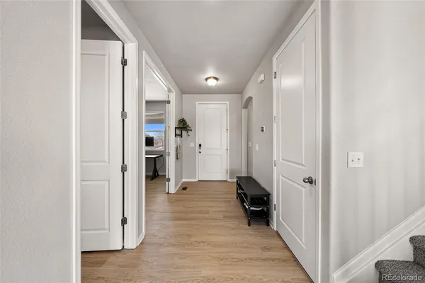 a view of a hallway with wooden shelves