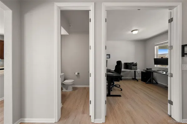 a view of a hallway with a livingroom and a couch