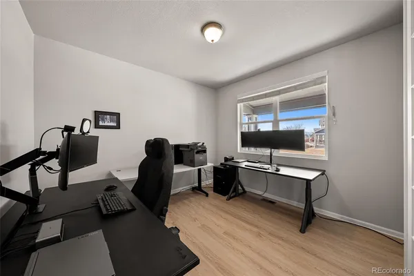 a view of a workspace with furniture and a window