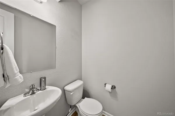 a white toilet sitting next to a bathroom sink