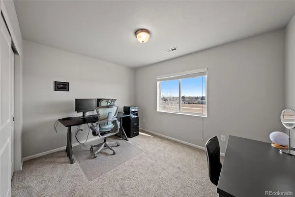 a work room with furniture and a window