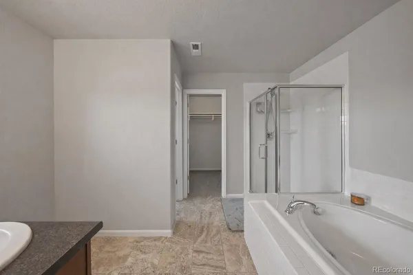 a bathroom with a bathtub and a sink