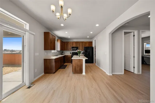 a kitchen with a refrigerator and a sink
