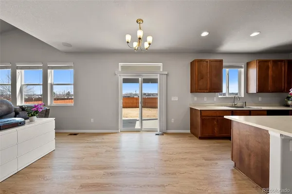 a large kitchen with stainless steel appliances granite countertop a stove and cabinets