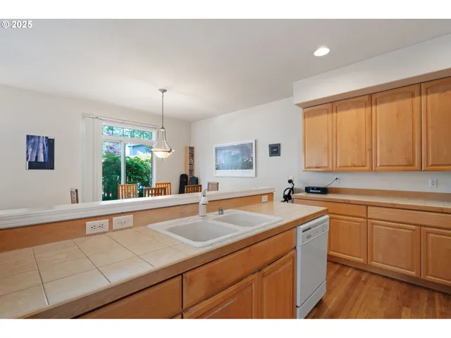a kitchen with a sink and large window