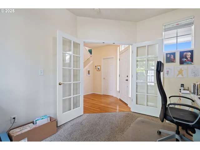 a view of a bedroom with furniture and windows