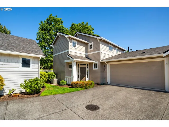 a view of a house with a yard and potted plants