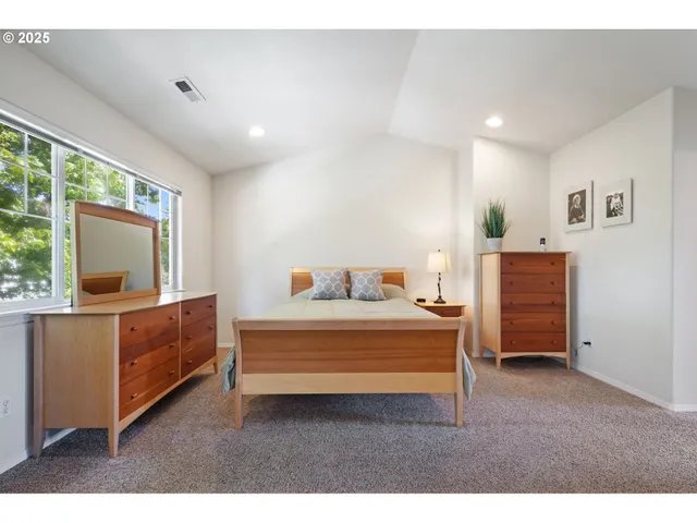 a living room with a bed furniture and a flat screen tv