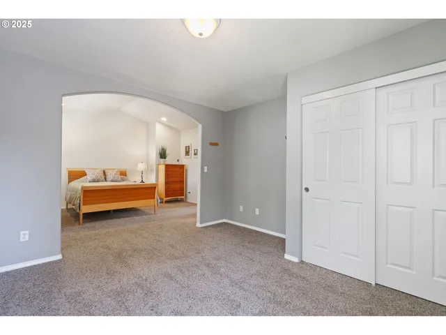 a living room with a couch and a night stand