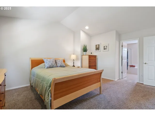 a bedroom with a bed and a night stand