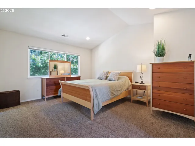 a bed room with a bed and a dresser