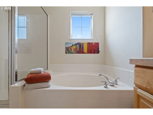 a bathroom with a tub sink and mirror