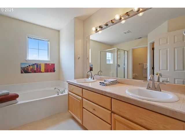 a bathroom with a tub sink and mirror