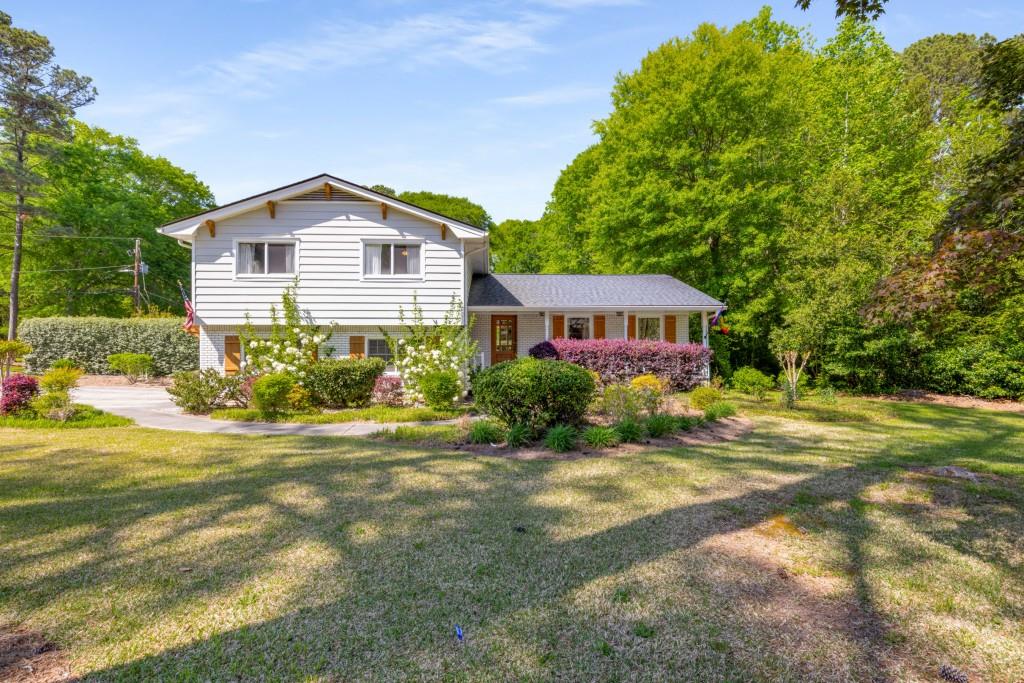 a front view of a house with a garden