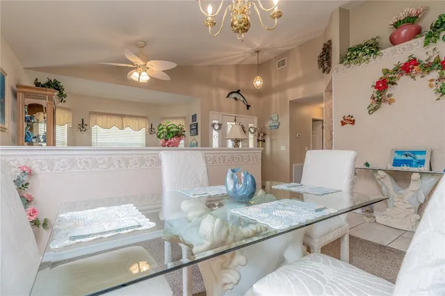 a living room with furniture a lamp and a chandelier