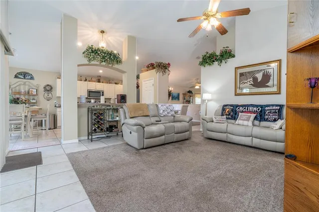 a living room with furniture fireplace and a large window