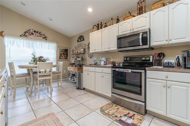 a kitchen with cabinets and stainless steel appliances