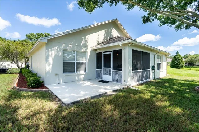 a view of a house with swimming pool and a yard