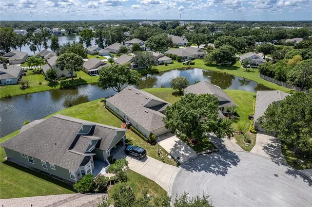 an aerial view of residential houses with outdoor space and parking
