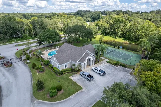 an aerial view of multiple houses with yard