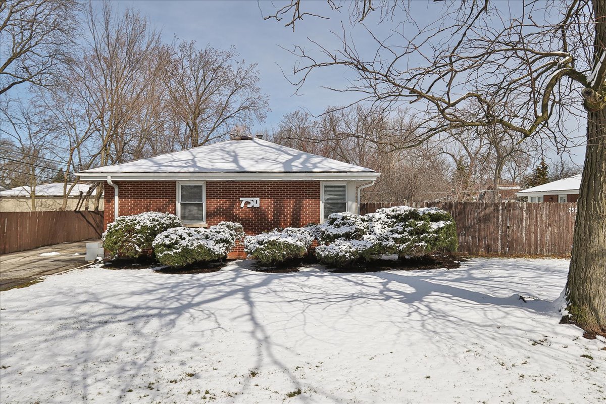 750 East Maple Street, Unit A Lombard, IL 60148 - Photo 1 of 26 a front view of a house with a garden and trees