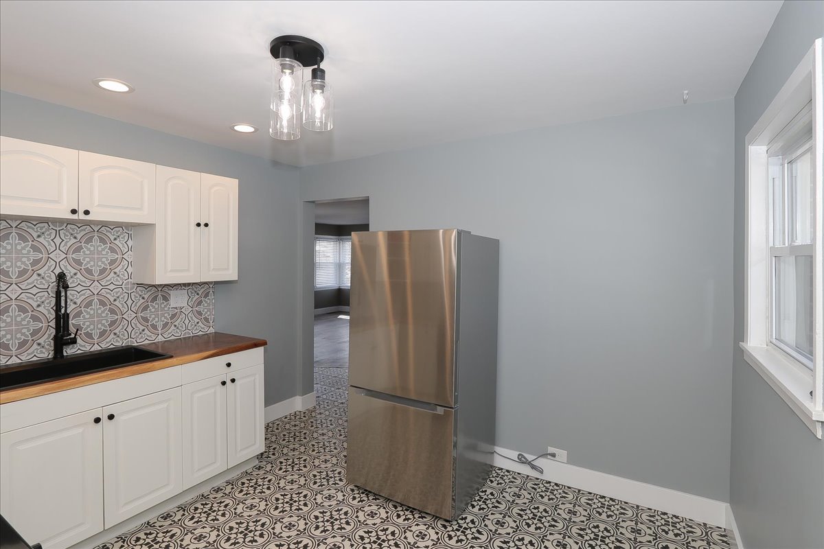 750 East Maple Street, Unit A Lombard, IL 60148 - Photo 11 of 26 a kitchen with stainless steel appliances granite countertop a refrigerator and a sink