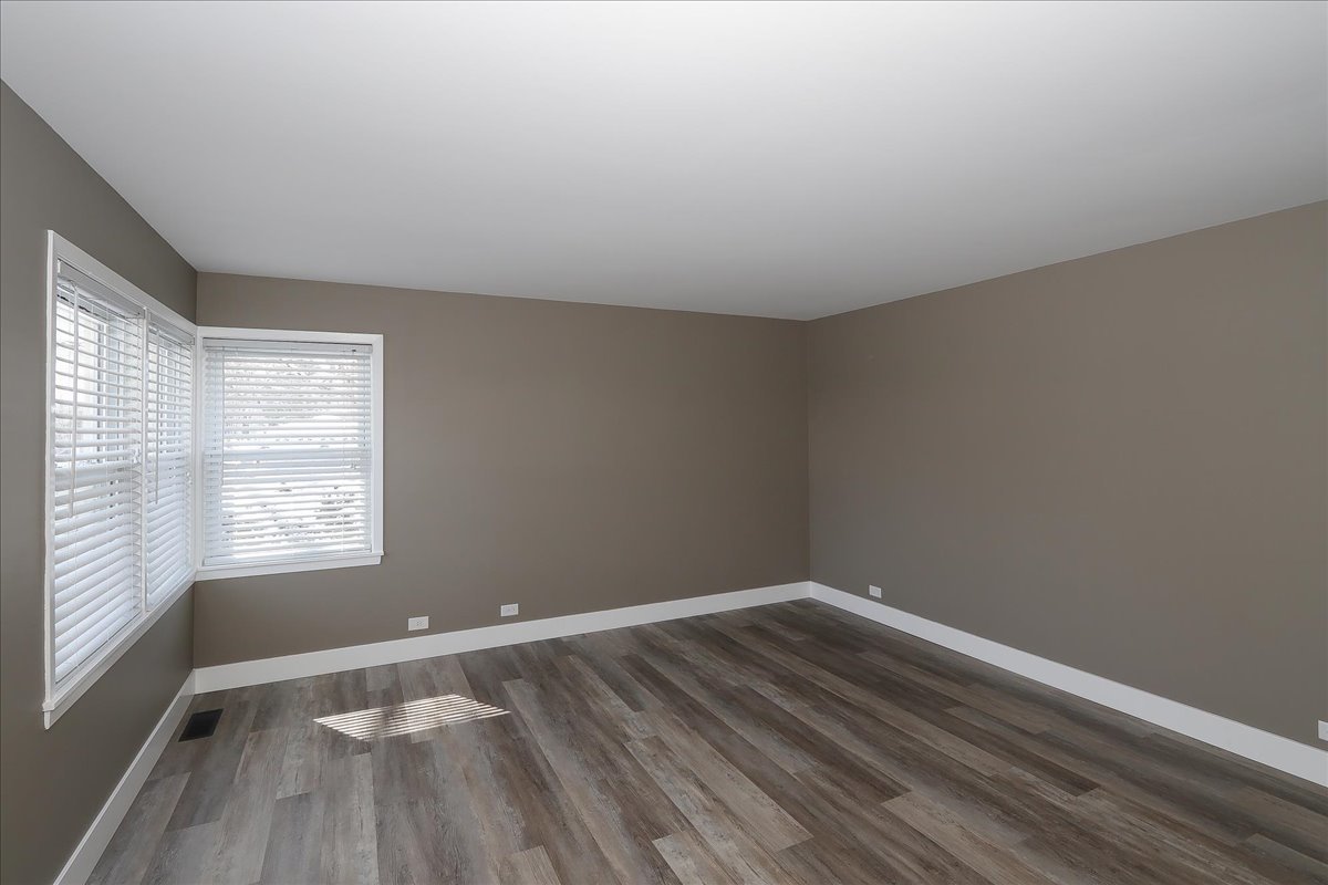 750 East Maple Street, Unit A Lombard, IL 60148 - Photo 4 of 26 wooden floor in an empty room with a window