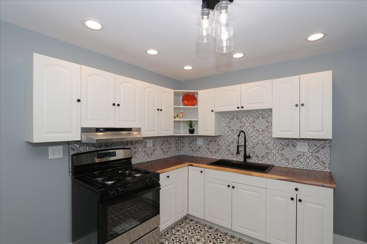 750 East Maple Street, Unit A Lombard, IL 60148 - Photo 8 of 26 a kitchen with granite countertop white cabinets and stainless steel appliances