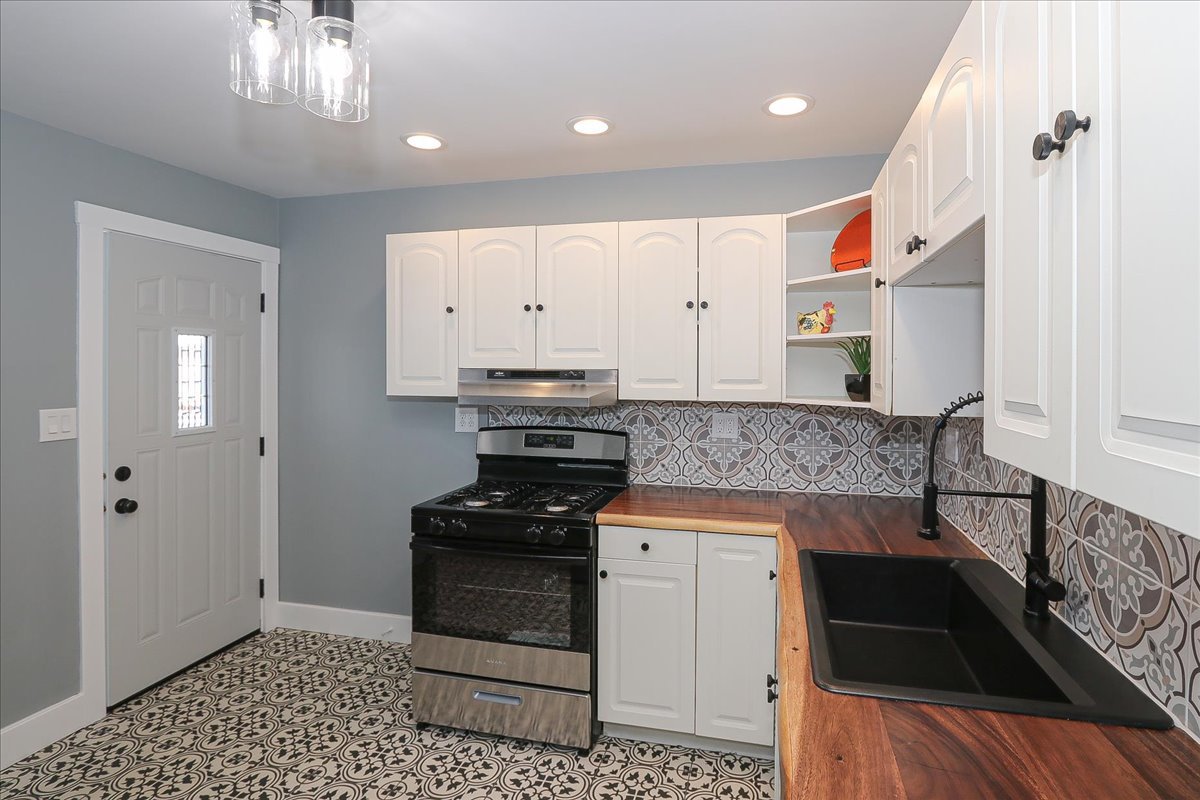 750 East Maple Street, Unit A Lombard, IL 60148 - Photo 9 of 26 a kitchen with granite countertop a stove a sink and a refrigerator