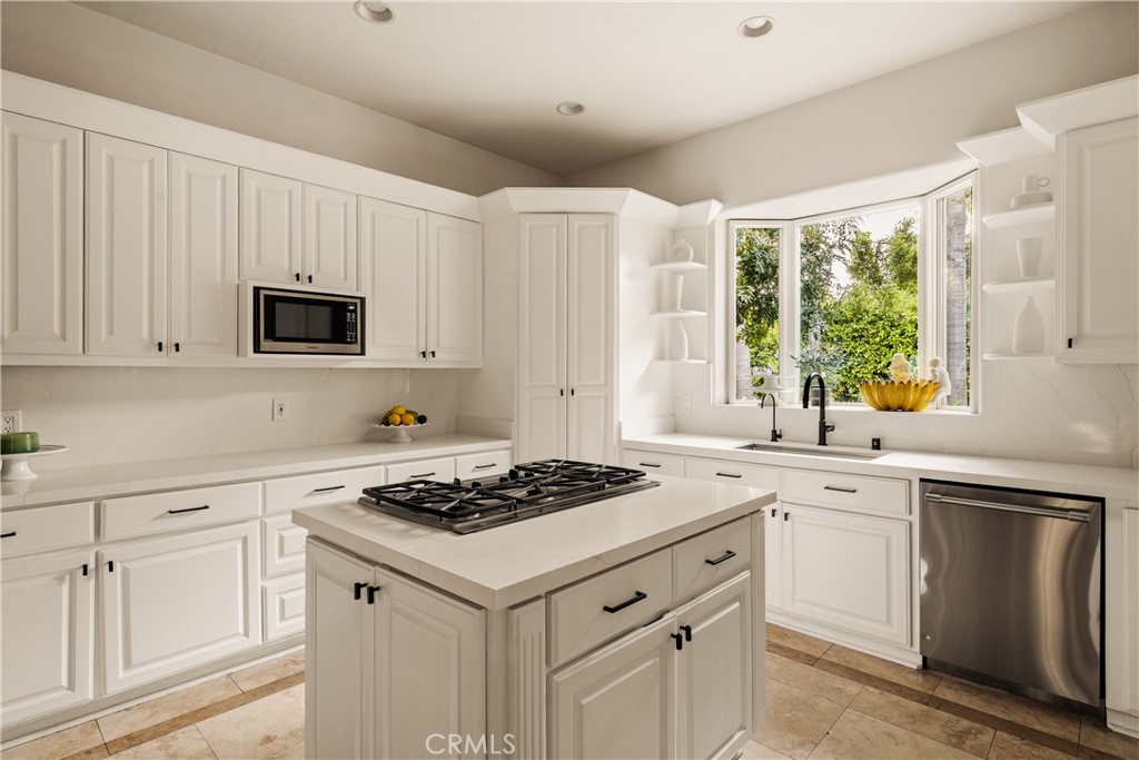 4210 Old Topanga Canyon Road Calabasas, CA 91302 - Photo 9 of 40 a kitchen with white cabinets stove and sink