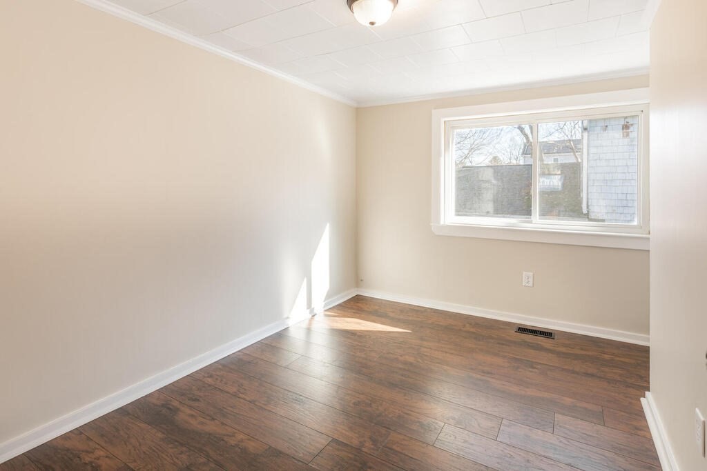 57 West Shore Road Holbrook, MA 02343 - Photo 7 of 13 an empty room with wooden floor and windows