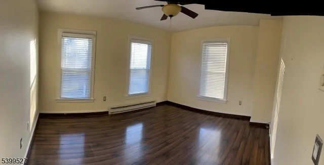 a view of wooden floor and windows in a room