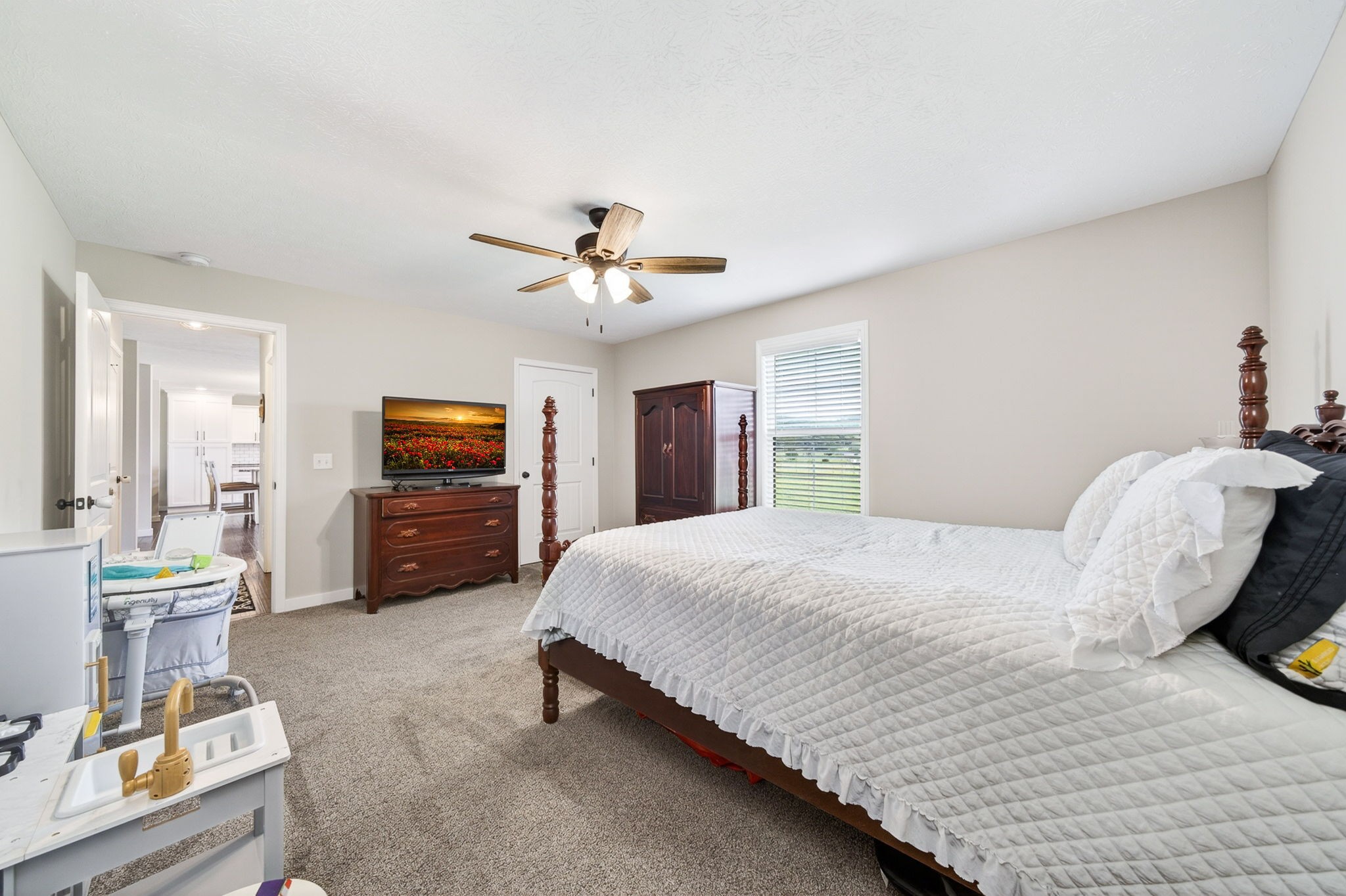 6810 Cherry Creek Road Cookeville, TN 38506 - Photo 8 of 35 a bedroom with a bed and a chandelier