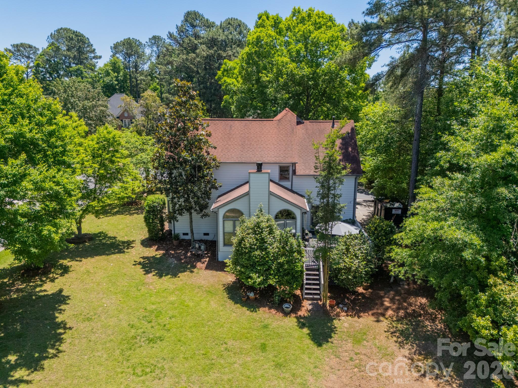 11043 Seven Coves Drive Tega Cay, SC 29708 - Photo 4 of 45 an aerial view of a house with a yard and large trees