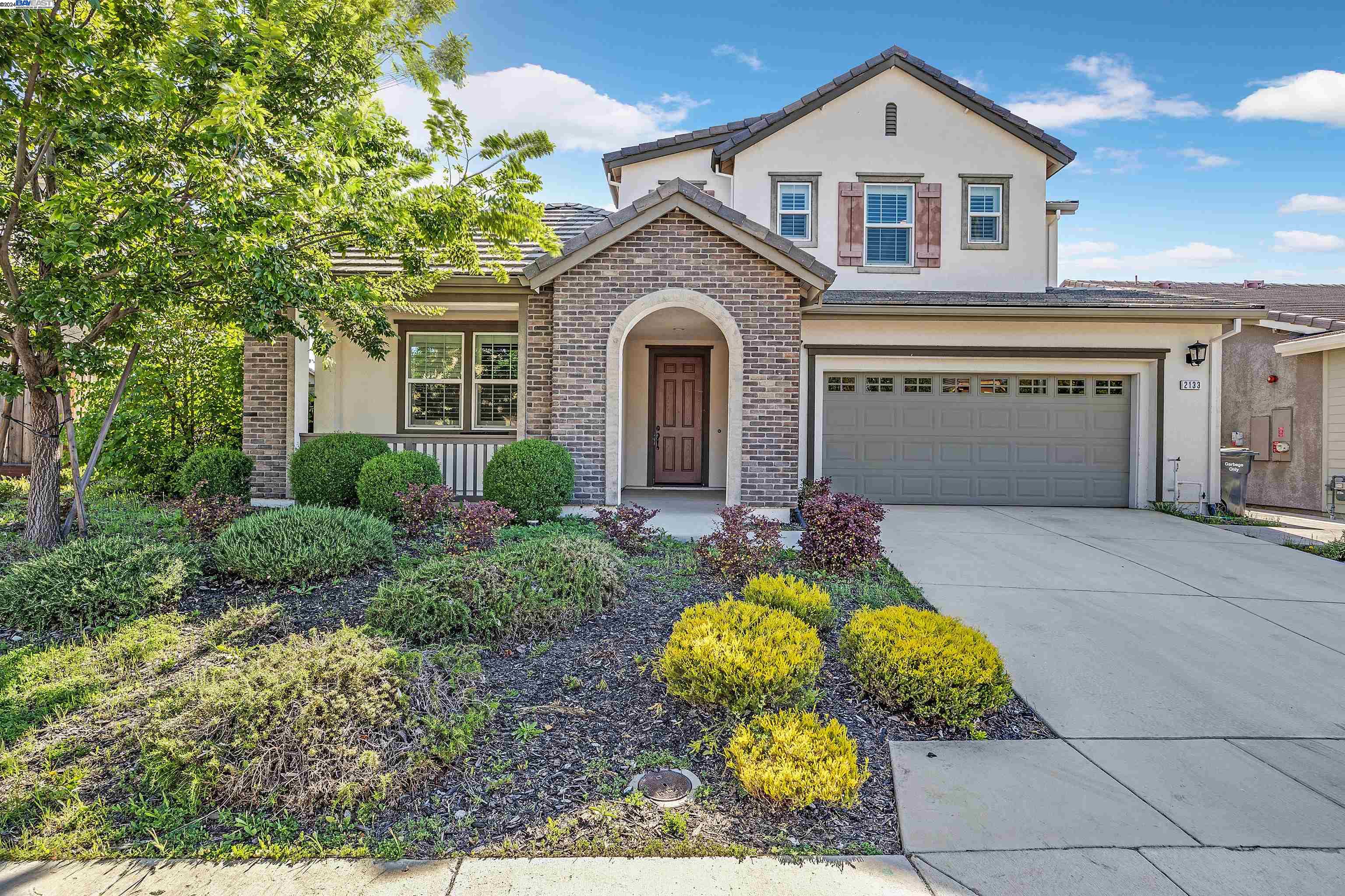a front view of a house with garden