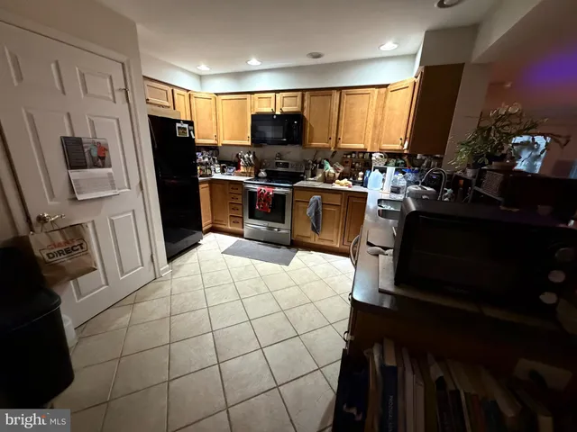 a kitchen with stainless steel appliances a refrigerator stove microwave and sink