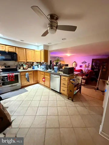 a kitchen with stainless steel appliances a stove a sink and cabinets