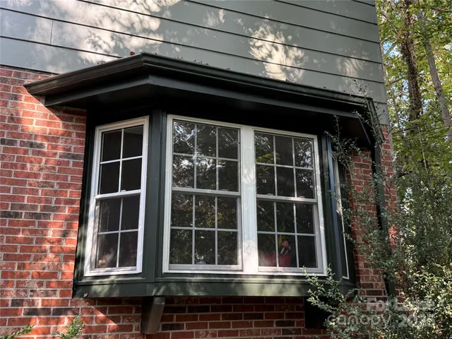 a balcony with wooden floor and outdoor seating