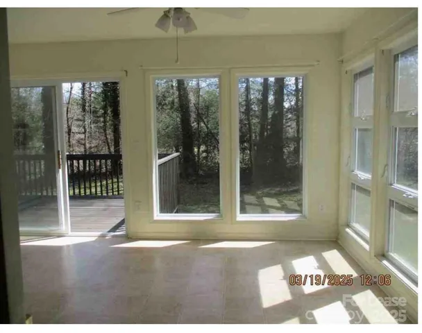 a blue house with trees in the background