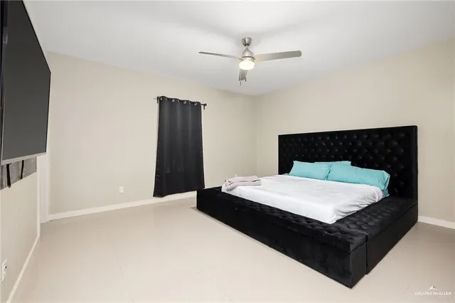 a spacious bedroom with a bed and cabinet