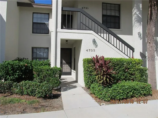 a view of a house with garden and plants
