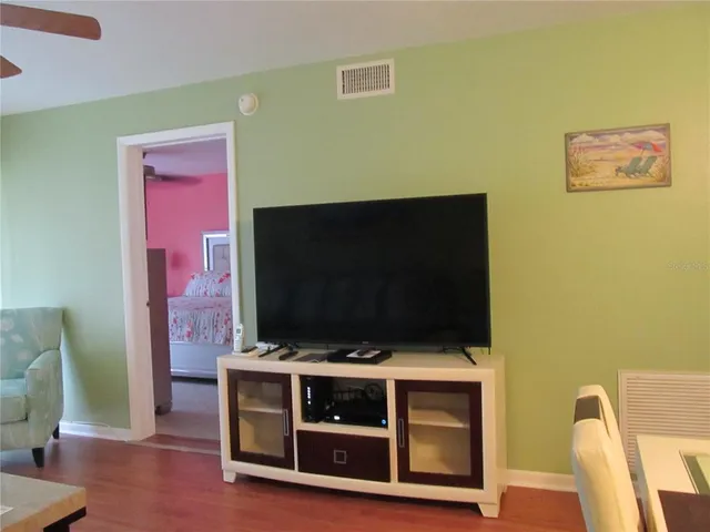 a living room with a flat screen tv and a fireplace