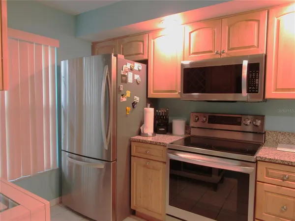 a kitchen with stainless steel appliances a refrigerator stove and microwave