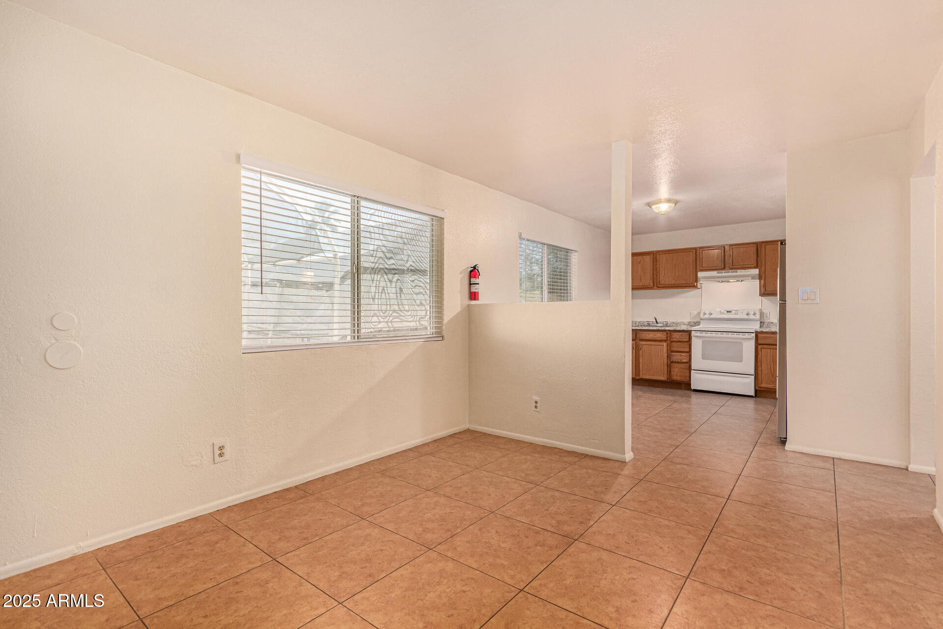 1318 East Culver Street, Unit 1 Phoenix, AZ 85006 - Photo 3 of 26 a view of a kitchen with furniture and an empty room
