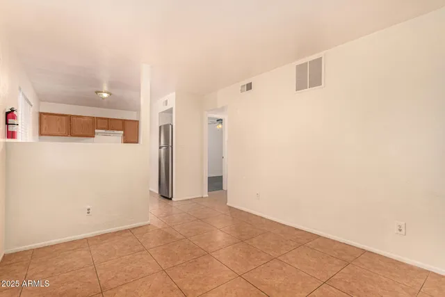a view of a kitchen with furniture and an empty room